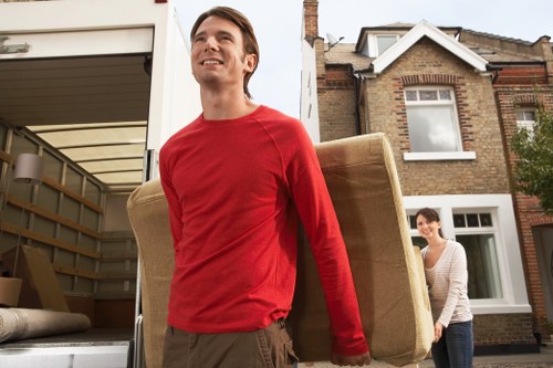 Removal crew handling office furniture in a Kennington commercial move