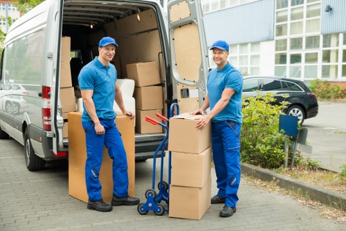 Removal crew moving office equipment through a Kennington building